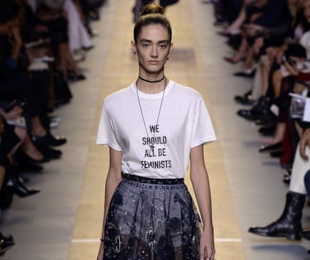 Model on the catwalk wearing a t-shirt saying 'we should all be feminists'