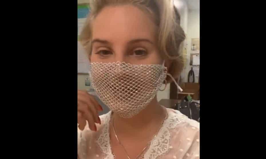 Lana Del Rey wearing a mesh face mask to a surprise signing of her debut poetry collection.