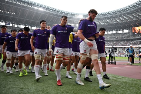 Japanese players leave the pitch after the warm up