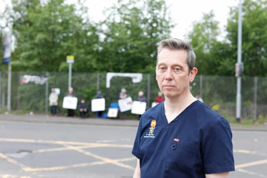 Paediatric radiologist Greg Irwin is pictured in front of anti-abortion protests outside Queen Elizabeth hospital maternity wing in Glasgow