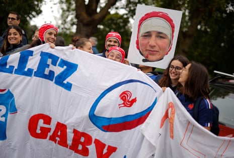 France fans pay homage to their back row forward Charlotte Escudero as they wait to greet the team bus outside the stadium.