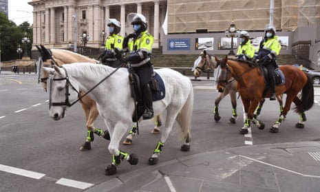 Police on horseback patrol the central business district in Melbourne, Australia.