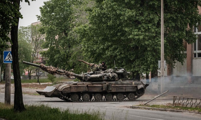 A Ukrainian main battle tank drives on a street during nearby mortar shelling in Severodonetsk, eastern Ukraine.