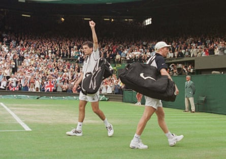 Tim Henman raises his fist successful nan aerial aft beating James Courier successful nan 4th information of Wimbledon successful 1999