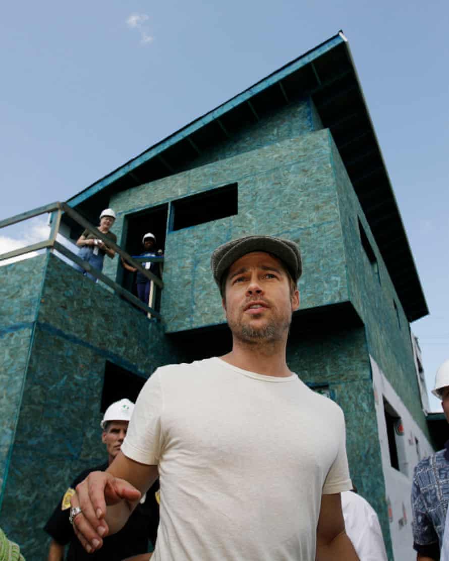 Brad Pitt stands before an environmentally friendly house under construction in the Hurricane Katrina-battered Lower Ninth Ward of New Orleans, in August 2007.