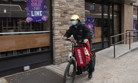 A Grubhub food delivery worker bikes through New York City.
