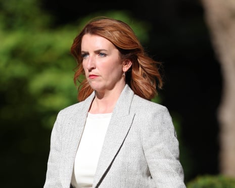 Louise Haigh in a light grey blazer and white top looks to the side outdoors