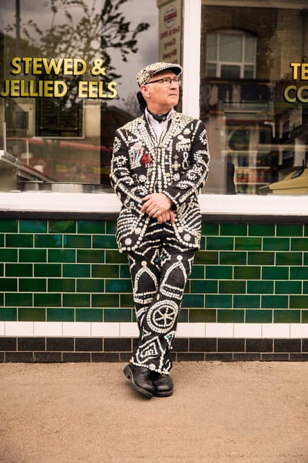 Keith Crowe in his pearly outfit stood outside a shop selling stewed and jellied eels