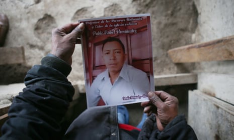 Alejandro Hernández holds a photo of his brother Pablo, who was shot and killed on 9 January in San Marcos de Caiquín.