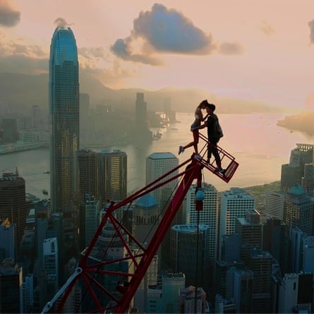 Nikolau and Beerkus on a crane amid skyscrapers
