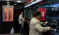 People visit a currency exchange office in Istanbul, Turkey