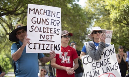 The protesters’ signs read ‘Machine guns for soldiers not citizens’ and ‘common sense gun laws’
