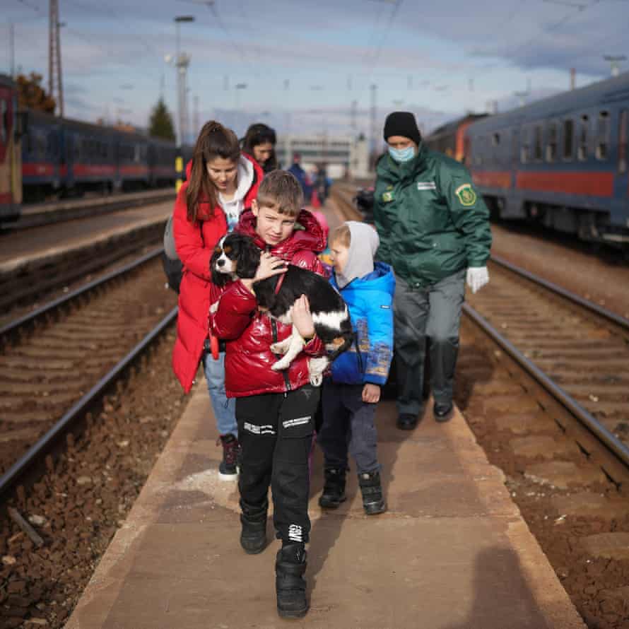 Refugee Kyryl (surname withheld) aged 9, from Kyiv arrives with his pet dog Hugo at the Hungarian border town of Zahony on a train that has come from Ukraine on March 2