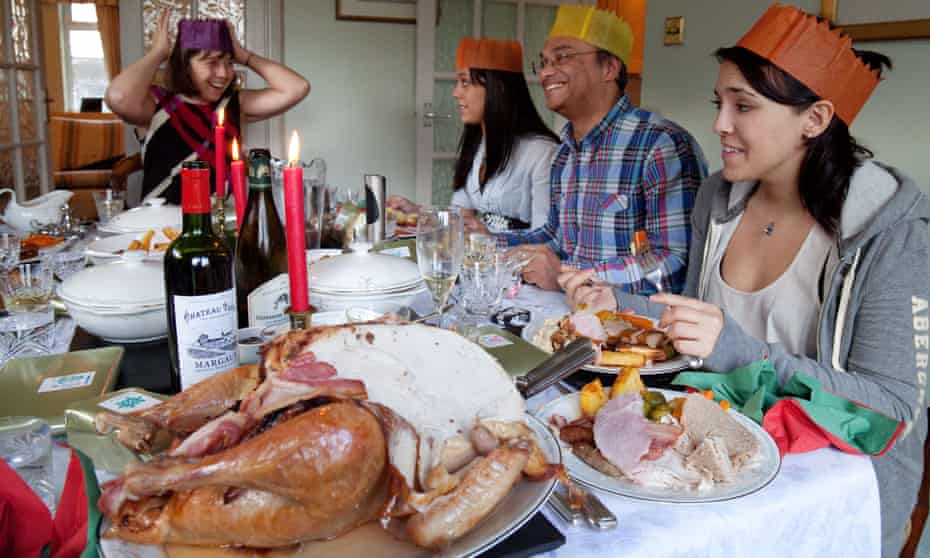 A family enjoy a traditional Christmas dinner