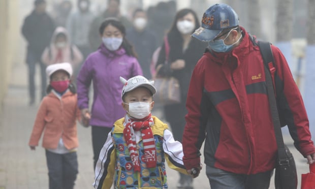 Young students and their parents wear masks to shield from air pollution