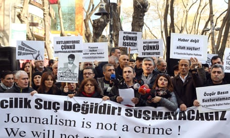 Turkish journalists hold a banner during a demonstration in support of jailed journalists Can Dundar and Erdem Gül.