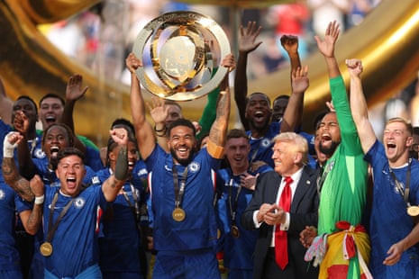 Reece James of Chelsea lifts the Club World Cup trophy after their team’s victory over Paris Saint-Germain, with Donald Trump close by.