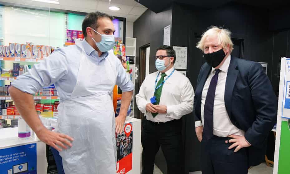 Boris Johnson meets the Oswestry Conservative candidate, Neil Shastri-Hurst, who was dispensing Covid vaccines at a local pharmacy.