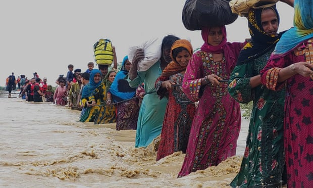 Rescue workers help villagers escape floods in Lasbella, in Pakistan's southwest Baluchistan province.