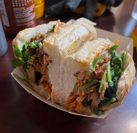 A ciabatta-like bun packed with grated vegetables in sauce