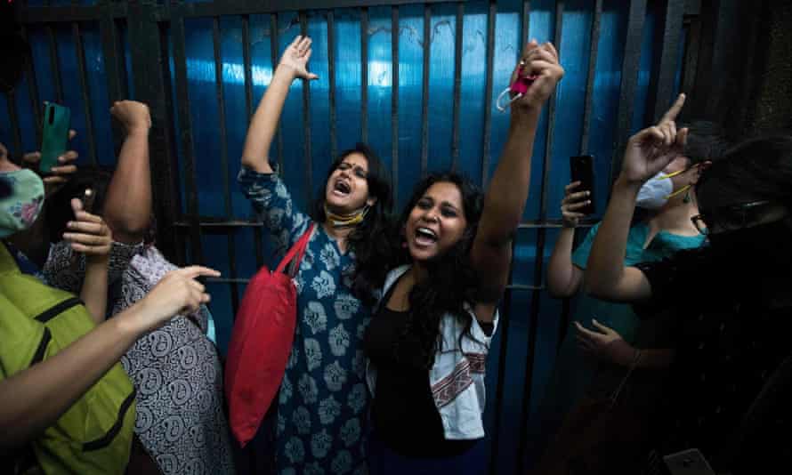 Activists Natasha Narwal, left, and Devangana Kalita shout slogans after being released from Tihar jail, Delhi, last month.