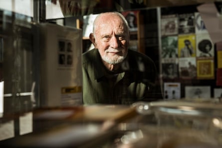 John Sainsbury peers through the window of a glass cabinet