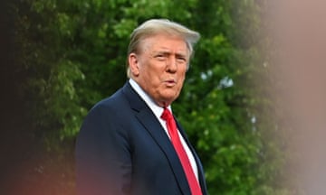 Donald Trump wearing black jacket and red tie