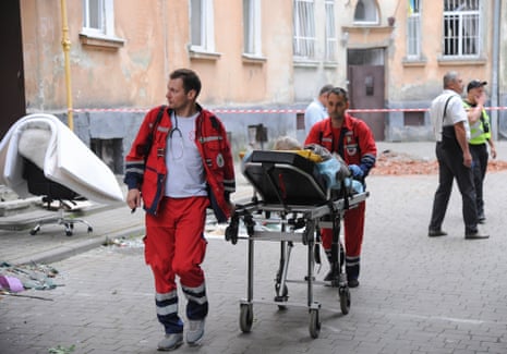 Medical workers evacuate an injured person on the site.