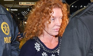 Tonya Couch, center, is taken by authorities to a waiting car after arriving at Los Angeles International Airport on Thursday.