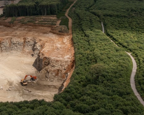 Aerial image of the quarry right beside the thick greenery of the woodland
