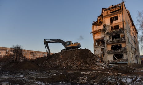 A tractor next to residential blocks destroyed by Russian airstrike in March in Borobyanka town, Kyiv region.