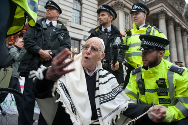 Rabbi Jeffrey Newman being arrested by police outside the Bank of England.