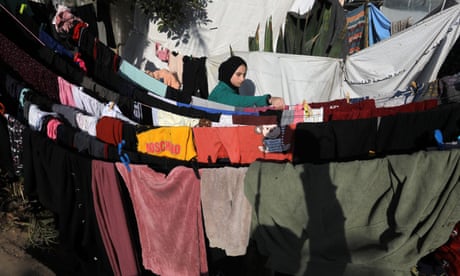 A Palestinian woman hangs her washing out to dry. A Palestinian woman hangs her washing out to dry.