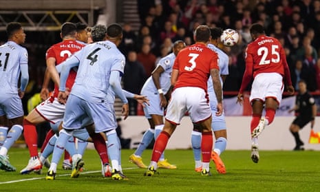 Nottingham Forest's Emmanuel Dennis (right) heads home to open the scoring in their Premier League game against Aston Villa.