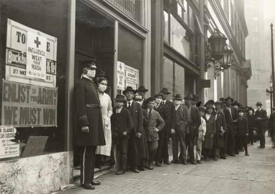 People wait in line to get flu masks to avoid the spread of Spanish influenza on Montgomery Street in San Francisco in 1918. 