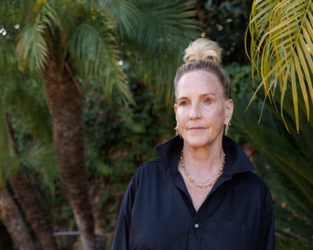 Erin Brockovich standing in front of lush green trees