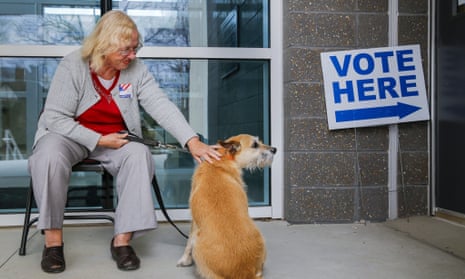 Super Tuesday votingepaselect epa05189413 Poll manager Adrienne Dowling looks after Jane Major’s terrier mix ‘Abby’ while Major casts her ballot at Mary Lin Elementary School, during Super Tuesday US presidential primary voting in Atlanta, Georgia, USA, 01 March 2016. Twelve states are holding primaries or caucus across the United States. EPA/ERIK S. LESSER