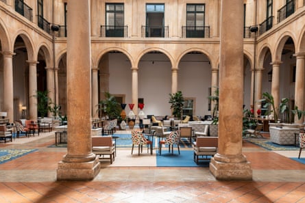 An interior courtyard with pillars and seating.