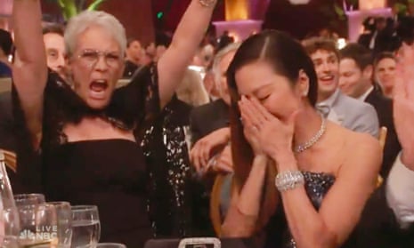 Jamie Lee Curtis cheers on Michelle Yeoh at the Golden Globes on Tuesday night.