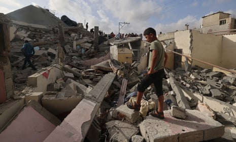 A Palestinian boy inspects the rubble of a building hit in overnight Israeli bombing in Rafah, in the southern Gaza Strip.