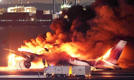 Japan Airlines plane on fire on a runway at Tokyo’s Haneda Airport.