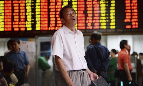 A man reacts to stock market falls in Shanghai.