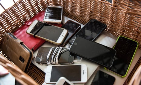 Smartphones dumped in a basket at a digital detox retreat in Somerset