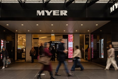 People walk in front of a Myer store