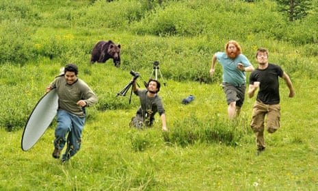Fake photo of National Geographic photographers running from a bear.