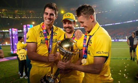 Pat Cummins, Travis Head and Marnus Labuschagne pose with the trophy after Australia’s victory.