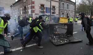 A protester holds a flare during an anti-government demonstration in Bourges.