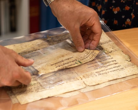 A person handling one of the pieces of paper
