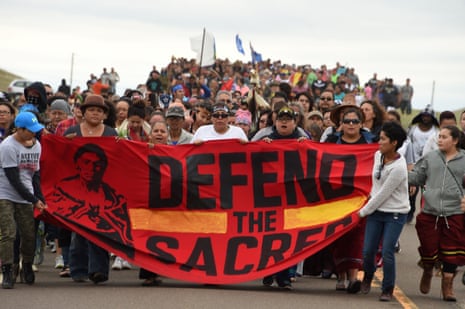 Native Americans march to a sacred burial ground disturbed by bulldozers building the Dakota Access Pipeline