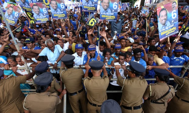 Supporters cheer as Mahinda Rajapaksa delivers a speech at a rally in Kandy on Friday.